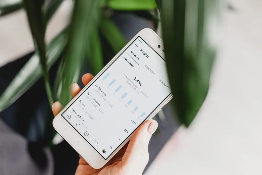 A creator reviewing their Instagram Insights on a phone